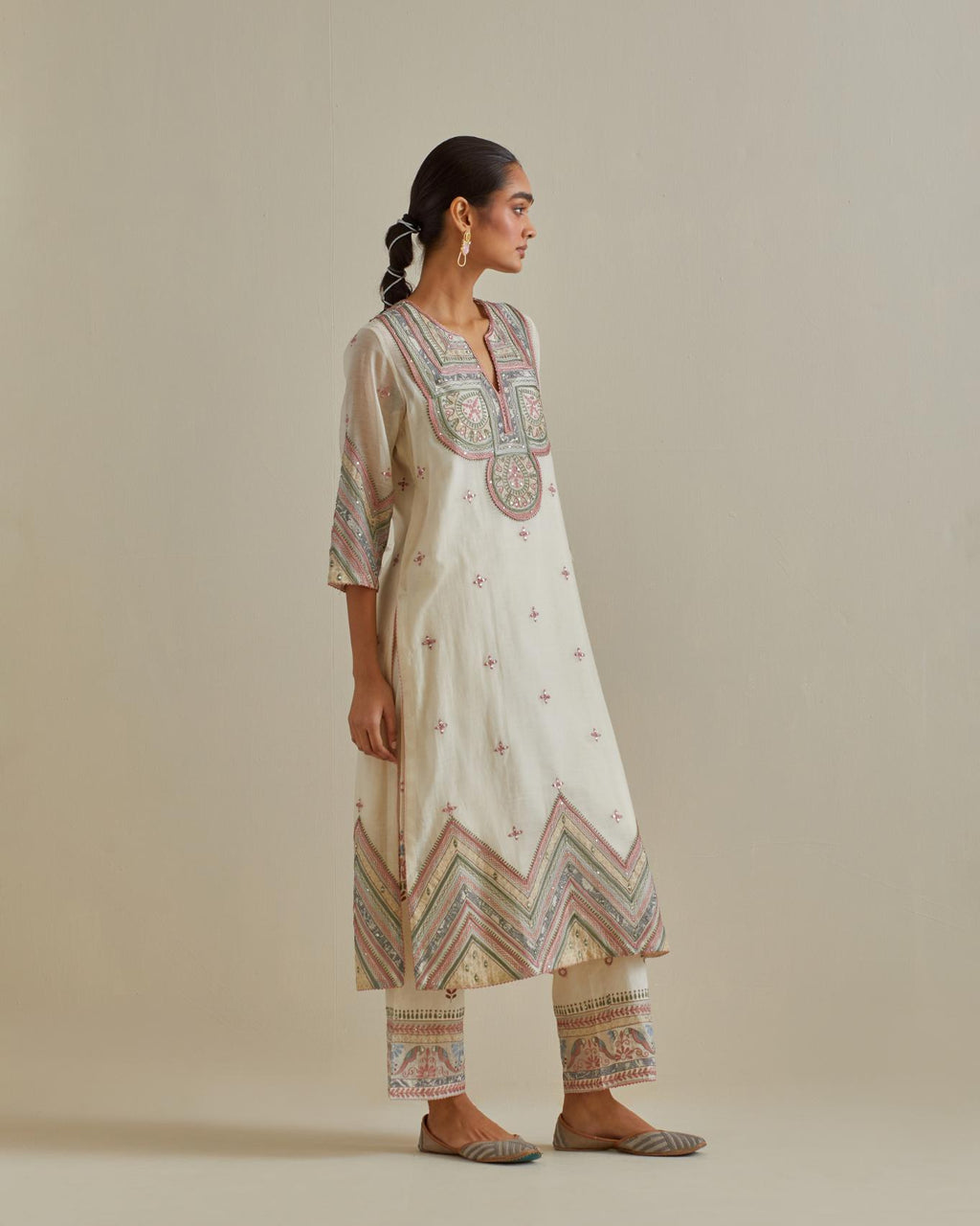 Pink and off-white cotton chanderi straight kurta set with patchwork and thread embroidery highlighted with mirrors, sequins, tassels and braids.