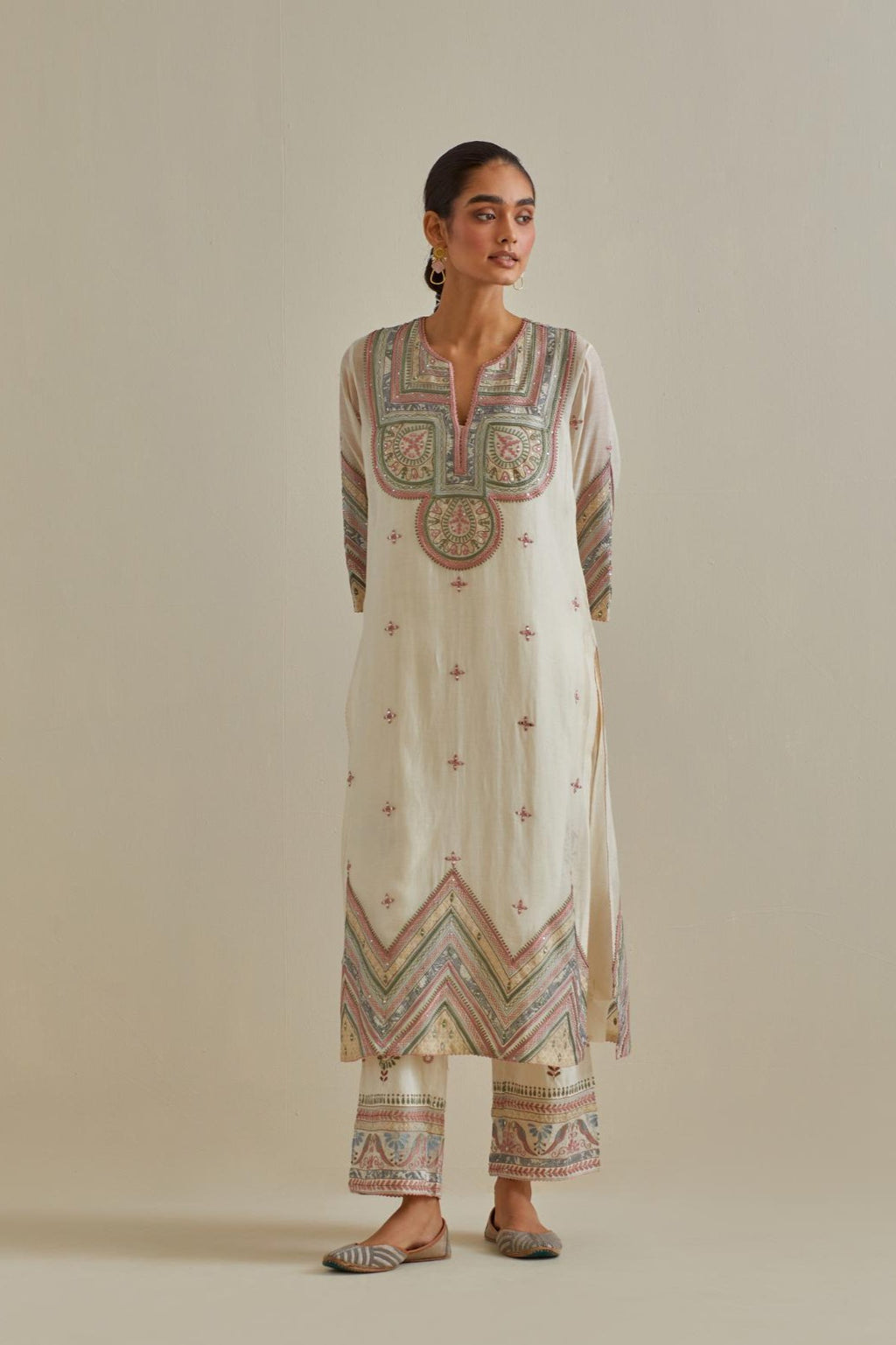 Pink and off-white cotton chanderi straight kurta set with patchwork and thread embroidery highlighted with mirrors, sequins, tassels and braids.