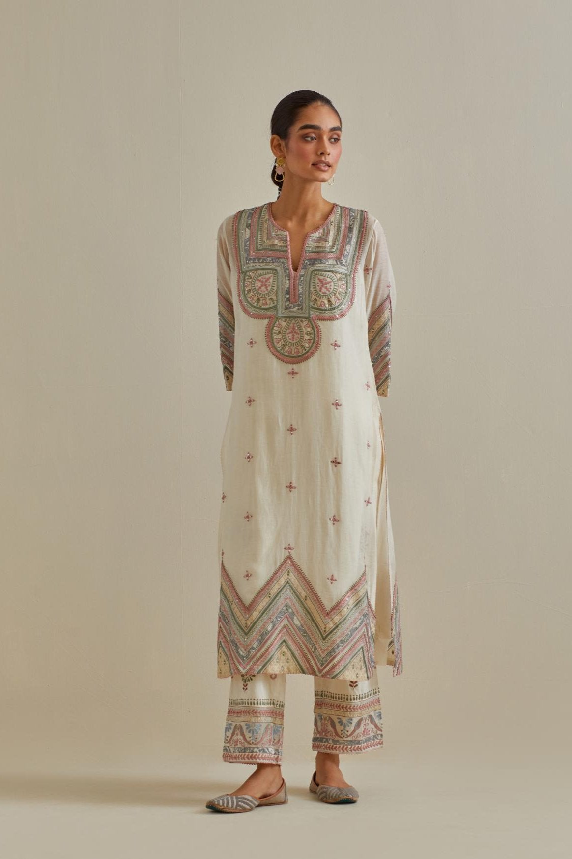 Pink and off-white cotton chanderi straight kurta set with patchwork and thread embroidery highlighted with mirrors, sequins, tassels and braids.