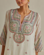 Pink and off-white cotton chanderi straight kurta set with patchwork and thread embroidery highlighted with mirrors, sequins, tassels and braids.