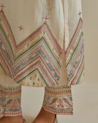 Pink and off-white cotton chanderi straight kurta set with patchwork and thread embroidery highlighted with mirrors, sequins, tassels and braids.