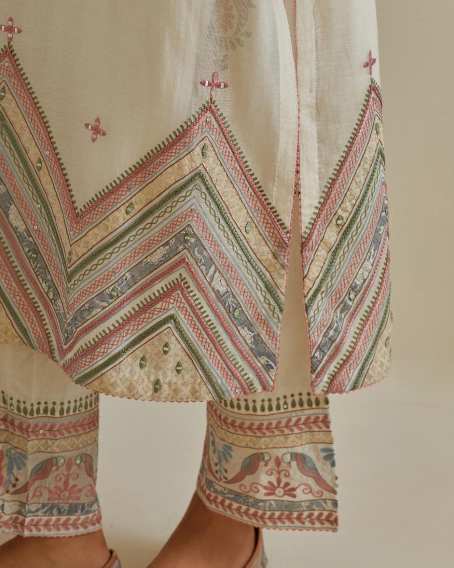 Pink and off-white cotton chanderi straight kurta set with patchwork and thread embroidery highlighted with mirrors, sequins, tassels and braids.