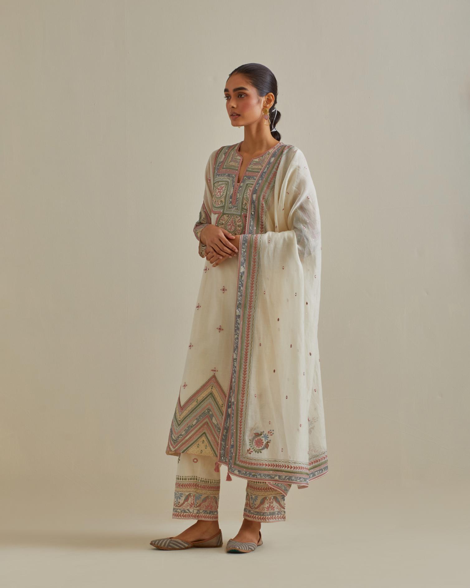 Pink and off-white cotton chanderi straight kurta set with patchwork and thread embroidery highlighted with mirrors, sequins, tassels and braids.