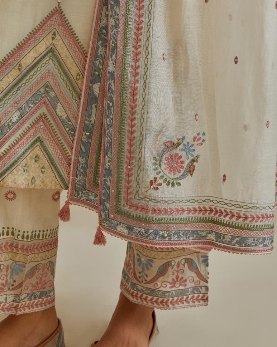 Pink and off-white cotton chanderi straight kurta set with patchwork and thread embroidery highlighted with mirrors, sequins, tassels and braids.