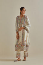 Pink and off-white cotton chanderi straight kurta set with patchwork and thread embroidery highlighted with mirrors, sequins, tassels and braids.