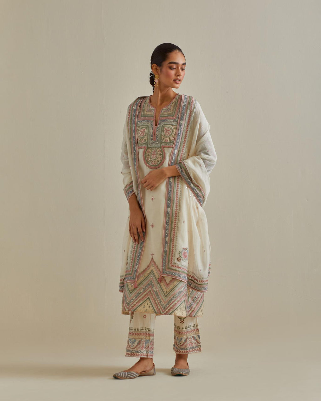 Pink and off-white cotton chanderi straight kurta set with patchwork and thread embroidery highlighted with mirrors, sequins, tassels and braids.