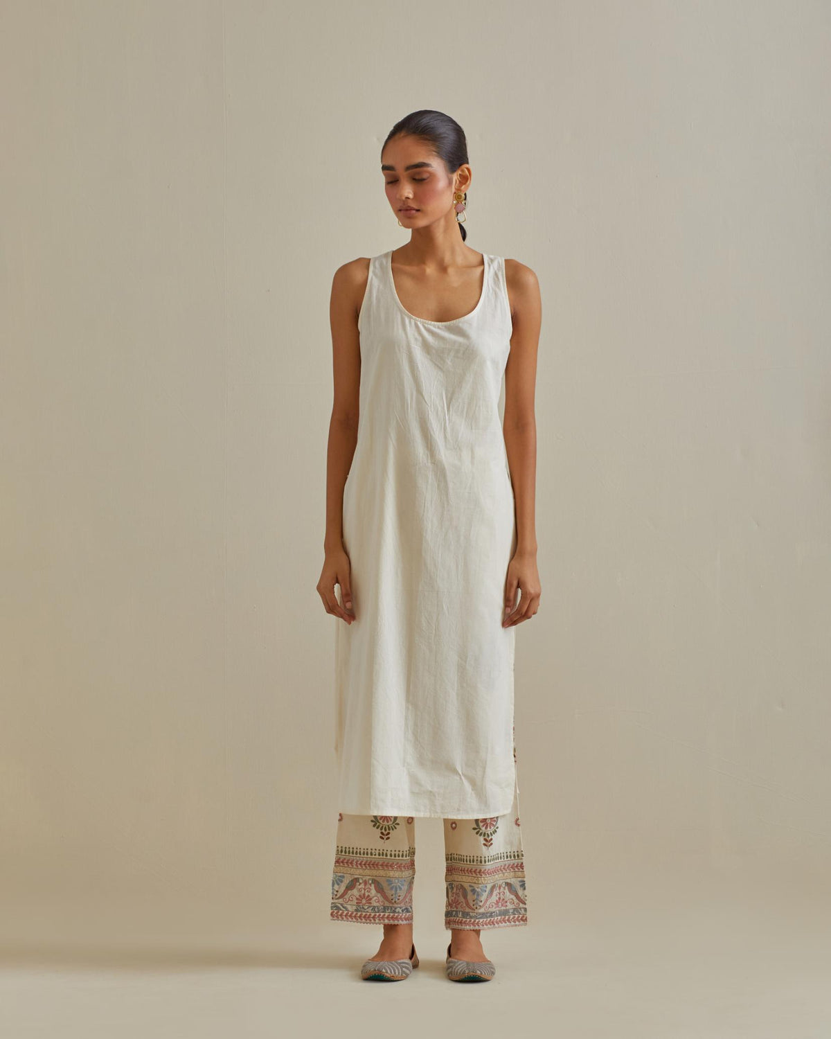 Pink and off-white cotton chanderi straight kurta set with patchwork and thread embroidery highlighted with mirrors, sequins, tassels and braids.