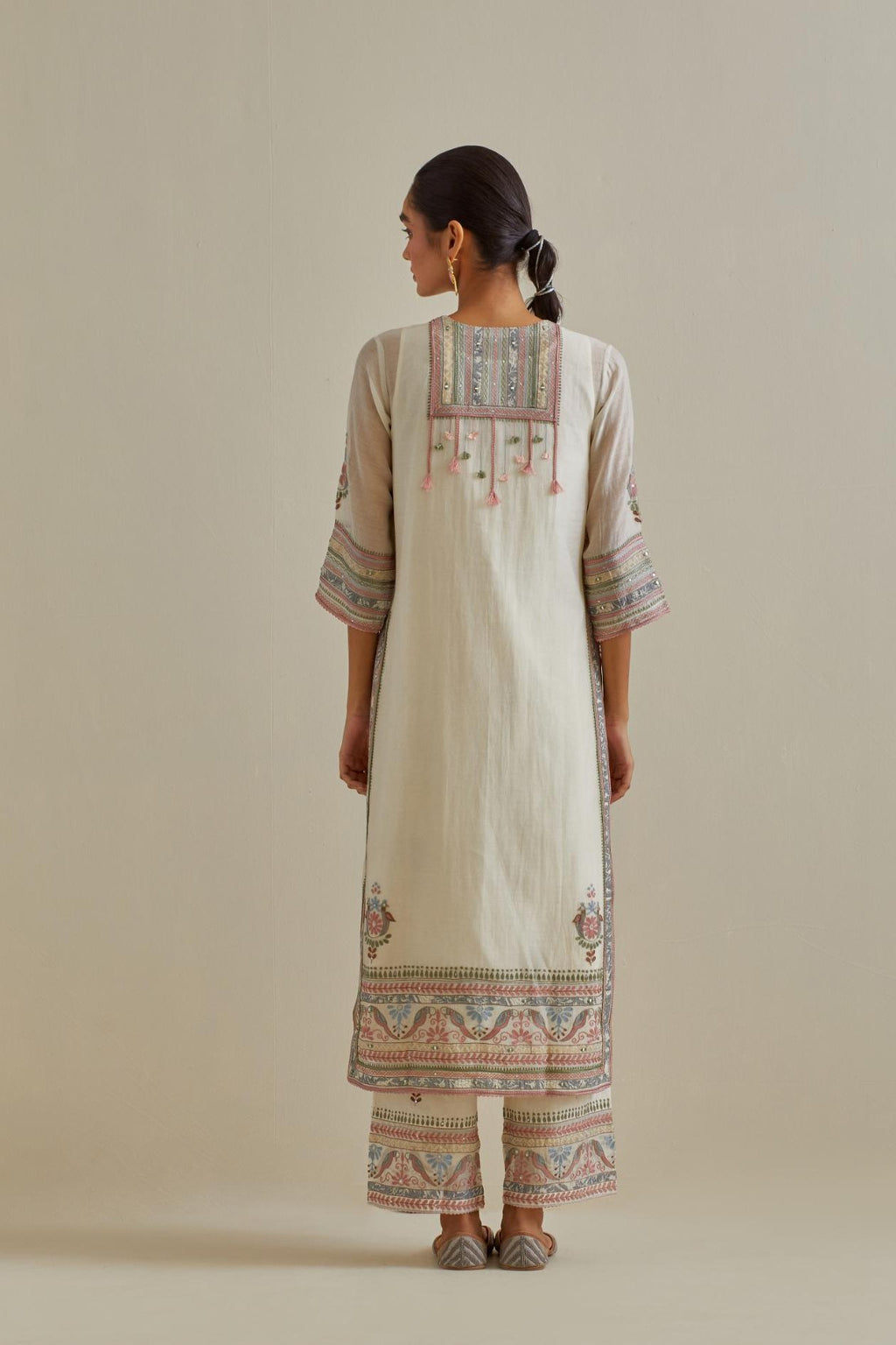 Pink and off-white cotton chanderi straight kurta set with yoke with patchwork and silk thread embroidery highlighted with mirror, sequins, tassels and braids.