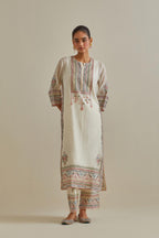 Pink and off-white cotton chanderi straight kurta set with yoke with patchwork and silk thread embroidery highlighted with mirror, sequins, tassels and braids.