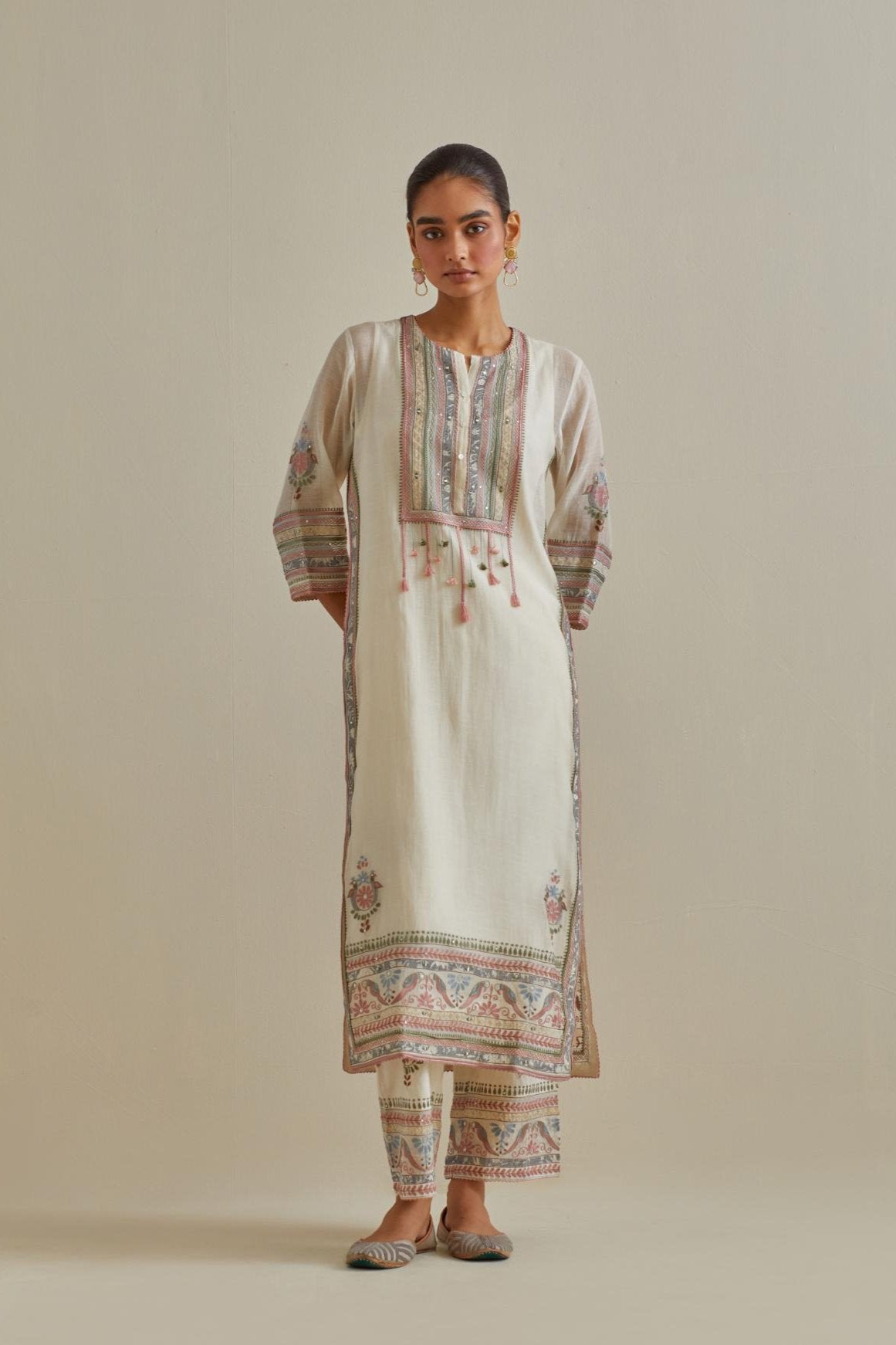 Pink and off-white cotton chanderi straight kurta set with yoke with patchwork and silk thread embroidery highlighted with mirror, sequins, tassels and braids.