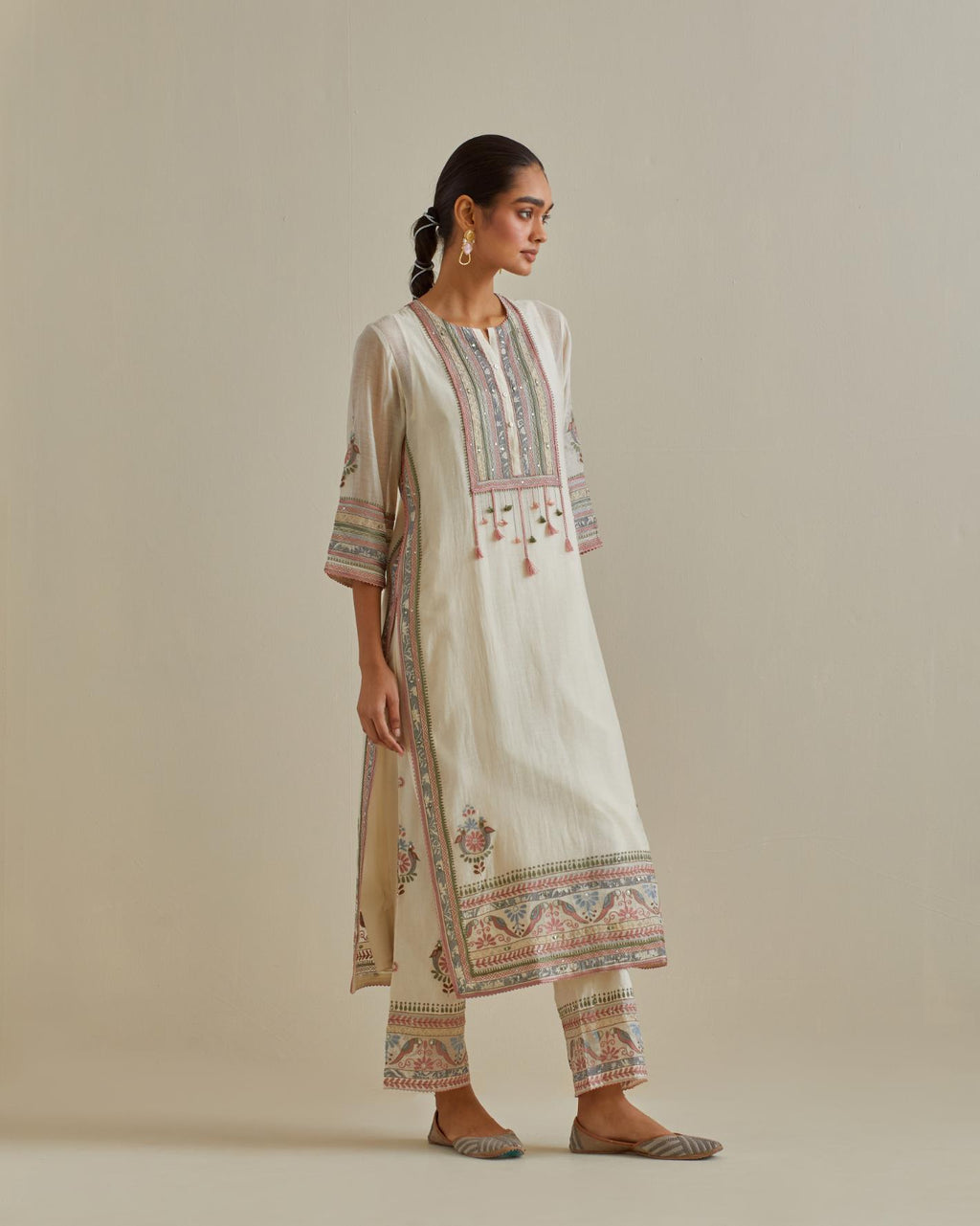 Pink and off-white cotton chanderi straight kurta set with yoke with patchwork and silk thread embroidery highlighted with mirror, sequins, tassels and braids.