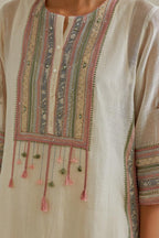 Pink and off-white cotton chanderi straight kurta set with yoke with patchwork and silk thread embroidery highlighted with mirror, sequins, tassels and braids.