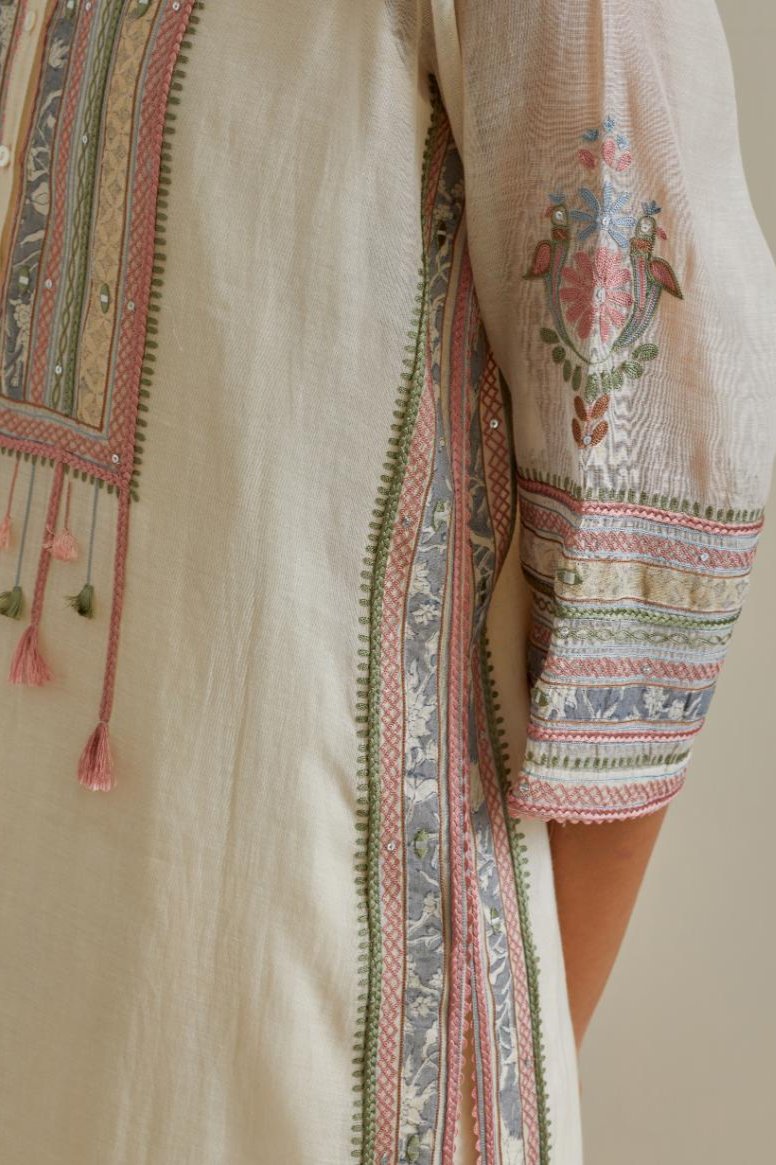 Pink and off-white cotton chanderi straight kurta set with yoke with patchwork and silk thread embroidery highlighted with mirror, sequins, tassels and braids.