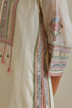 Pink and off-white cotton chanderi straight kurta set with yoke with patchwork and silk thread embroidery highlighted with mirror, sequins, tassels and braids.