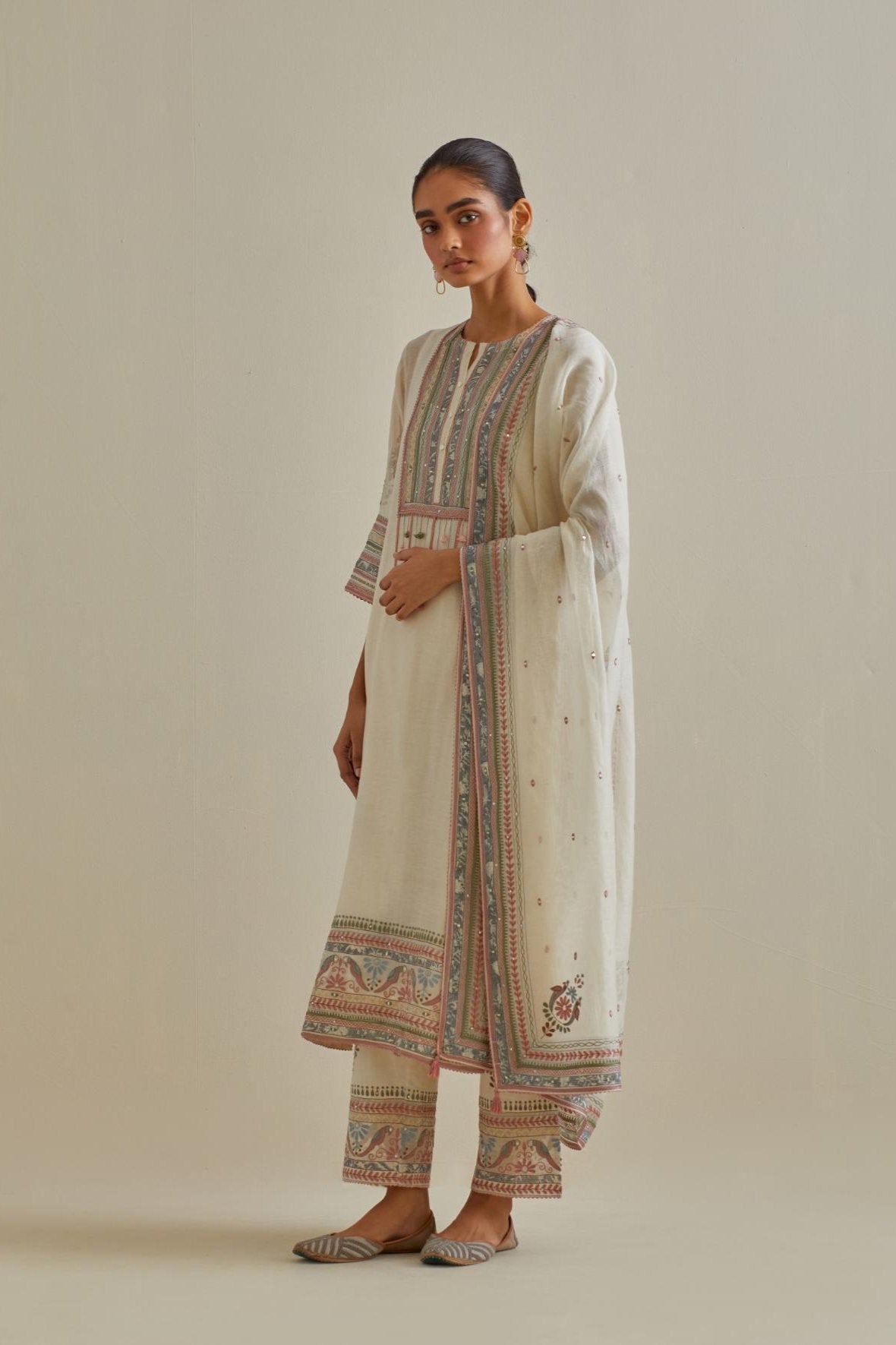 Pink and off-white cotton chanderi straight kurta set with yoke with patchwork and silk thread embroidery highlighted with mirror, sequins, tassels and braids.
