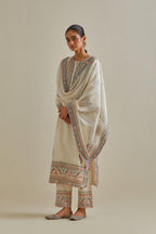 Pink and off-white cotton chanderi straight kurta set with yoke with patchwork and silk thread embroidery highlighted with mirror, sequins, tassels and braids.