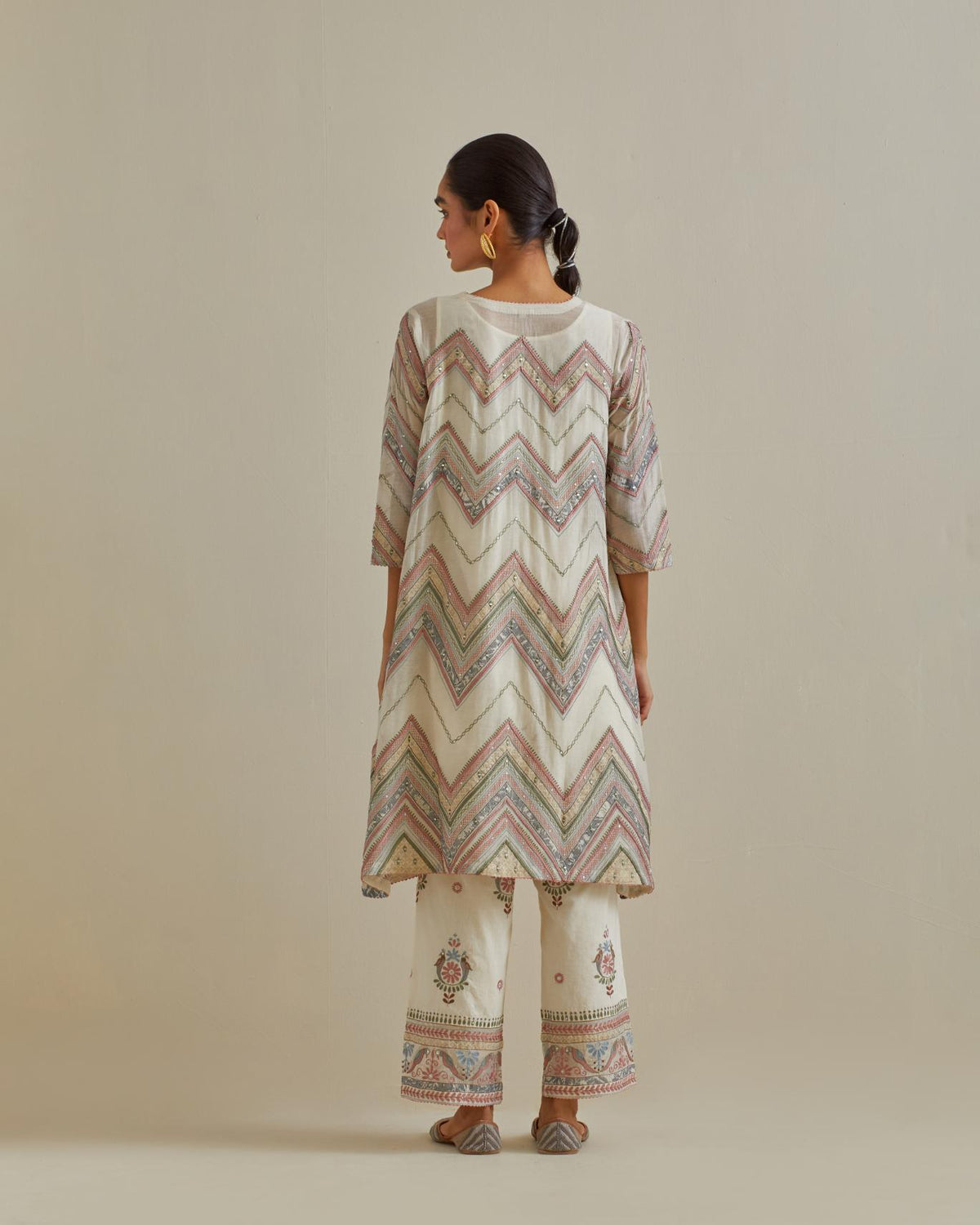 Pink and off-white cotton chanderi A-line kurta set with all over embroidery set in bold chevron stripes.