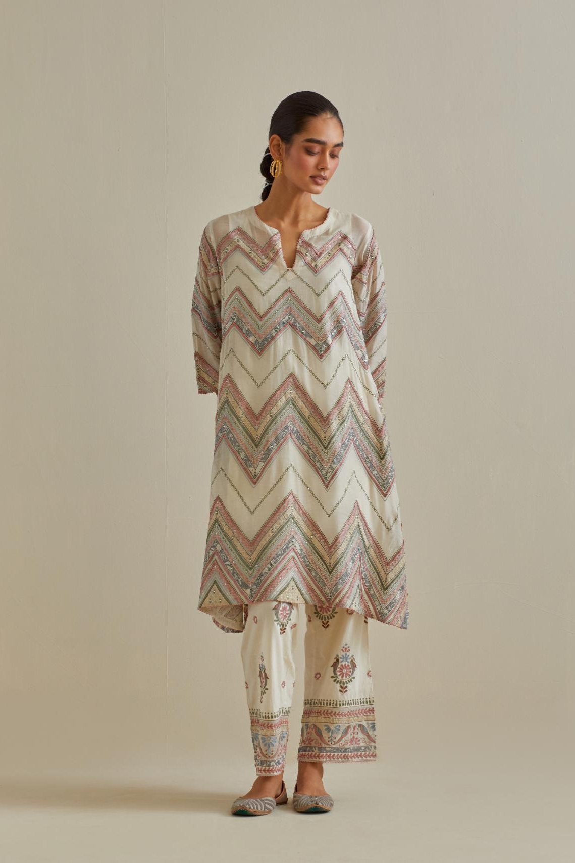 Pink and off-white cotton chanderi A-line kurta set with all over embroidery set in bold chevron stripes.