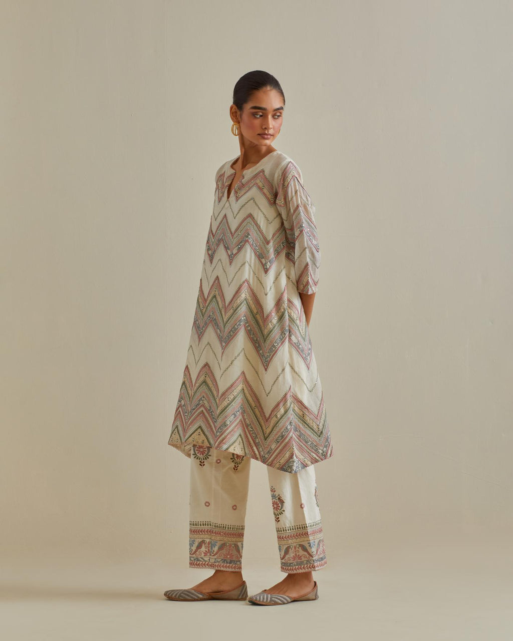 Pink and off-white cotton chanderi A-line kurta set with all over embroidery set in bold chevron stripes.