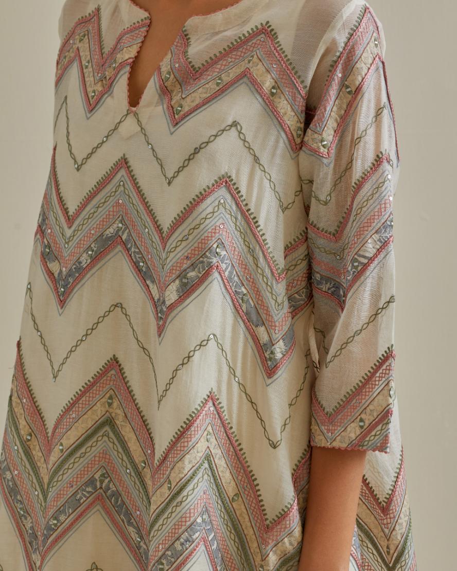 Pink and off-white cotton chanderi A-line kurta set with all over embroidery set in bold chevron stripes.