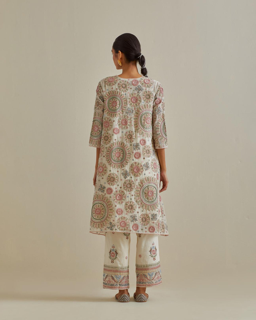 Pink and off-white A-line cotton chanderi kurta set with all over patchwork, silk thread, mirror, tassels and sequin embroidery.