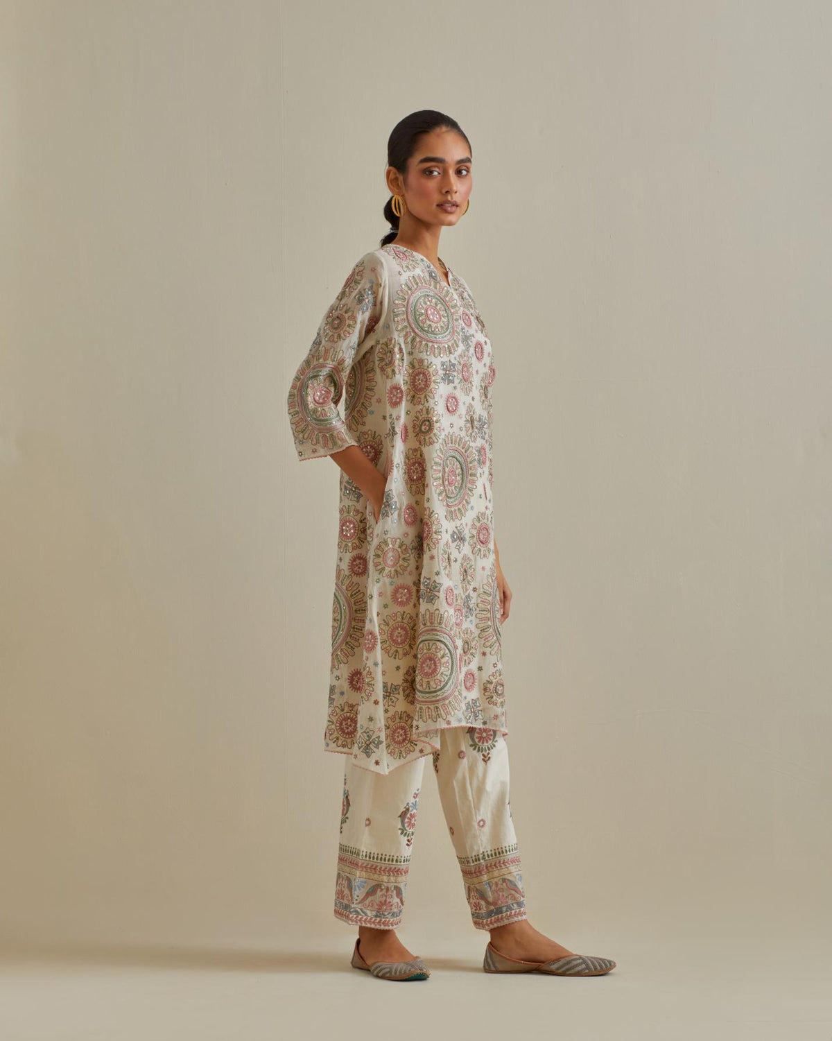 Pink and off-white A-line cotton chanderi kurta set with all over patchwork, silk thread, mirror, tassels and sequin embroidery.