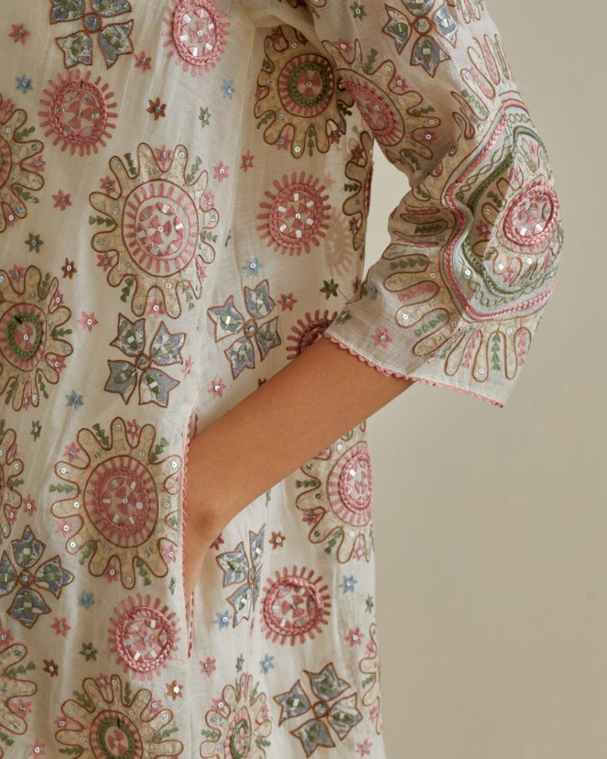 Pink and off-white A-line cotton chanderi kurta set with all over patchwork, silk thread, mirror, tassels and sequin embroidery.