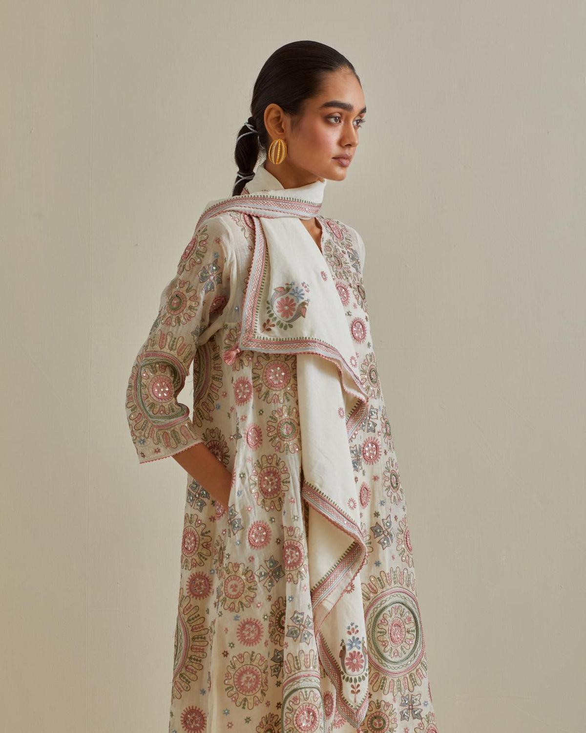 Pink and off-white A-line cotton chanderi kurta set with all over patchwork, silk thread, mirror, tassels and sequin embroidery.