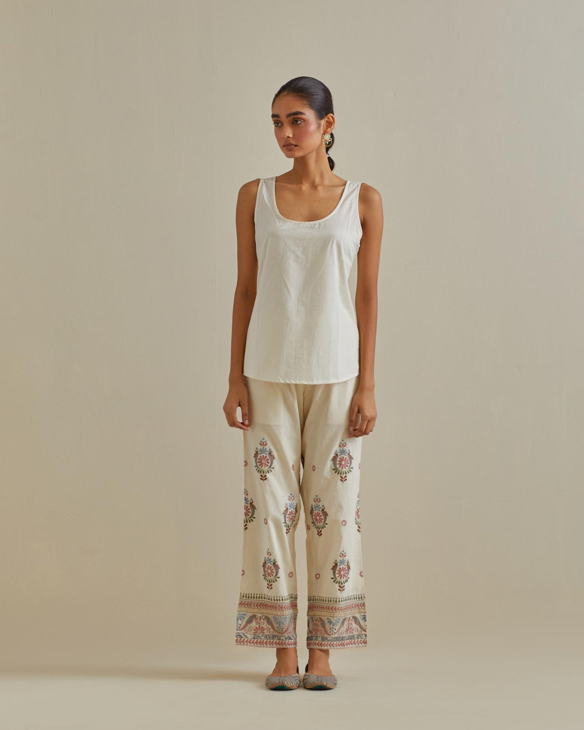 Pink and off-white cotton chanderi embroidered shirt with full sleeves, paired with off white cotton straight pants with all over multi color embroidery detailed with sequins.
