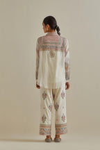 Pink and off-white cotton chanderi embroidered shirt with full sleeves, paired with off white cotton straight pants with all over multi color embroidery detailed with sequins.