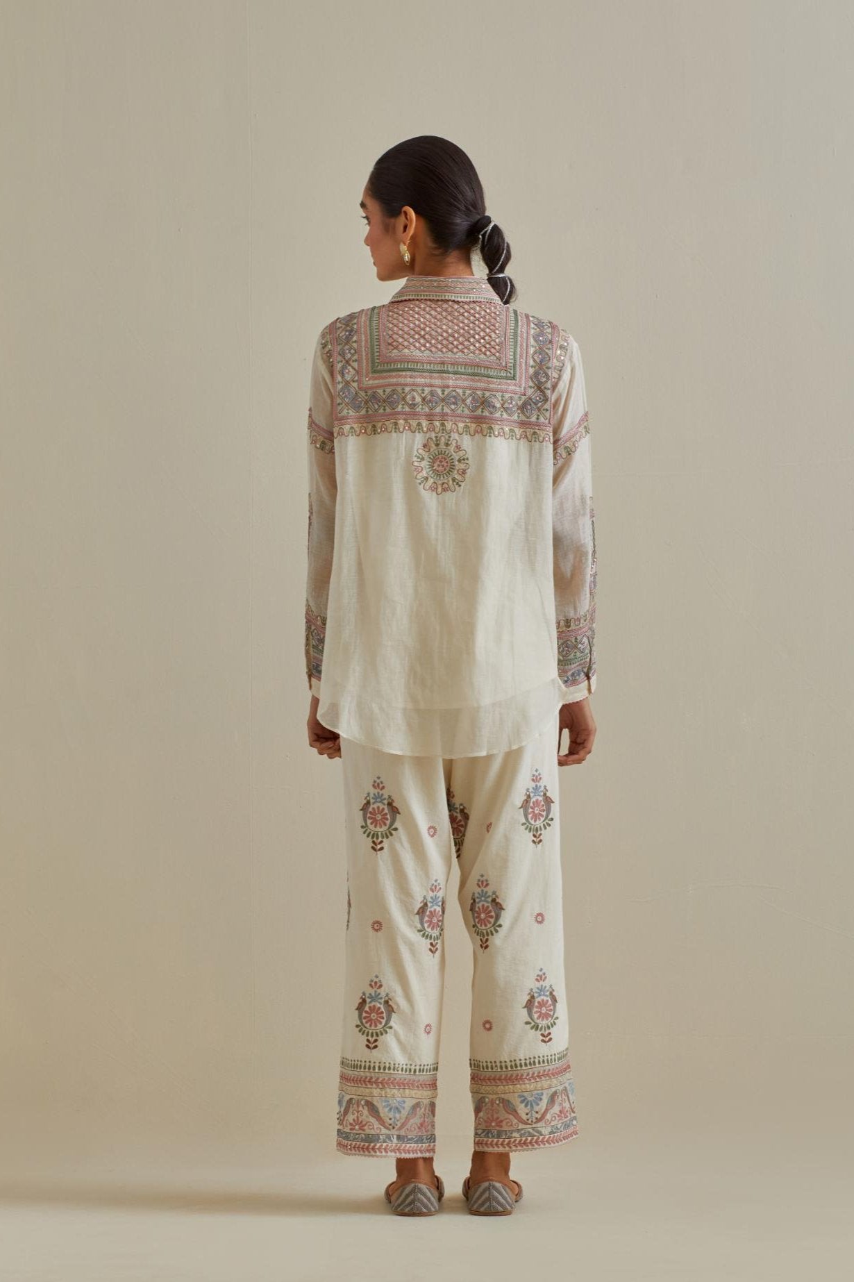 Pink and off-white cotton chanderi embroidered shirt with full sleeves, paired with off white cotton straight pants with all over multi color embroidery detailed with sequins.