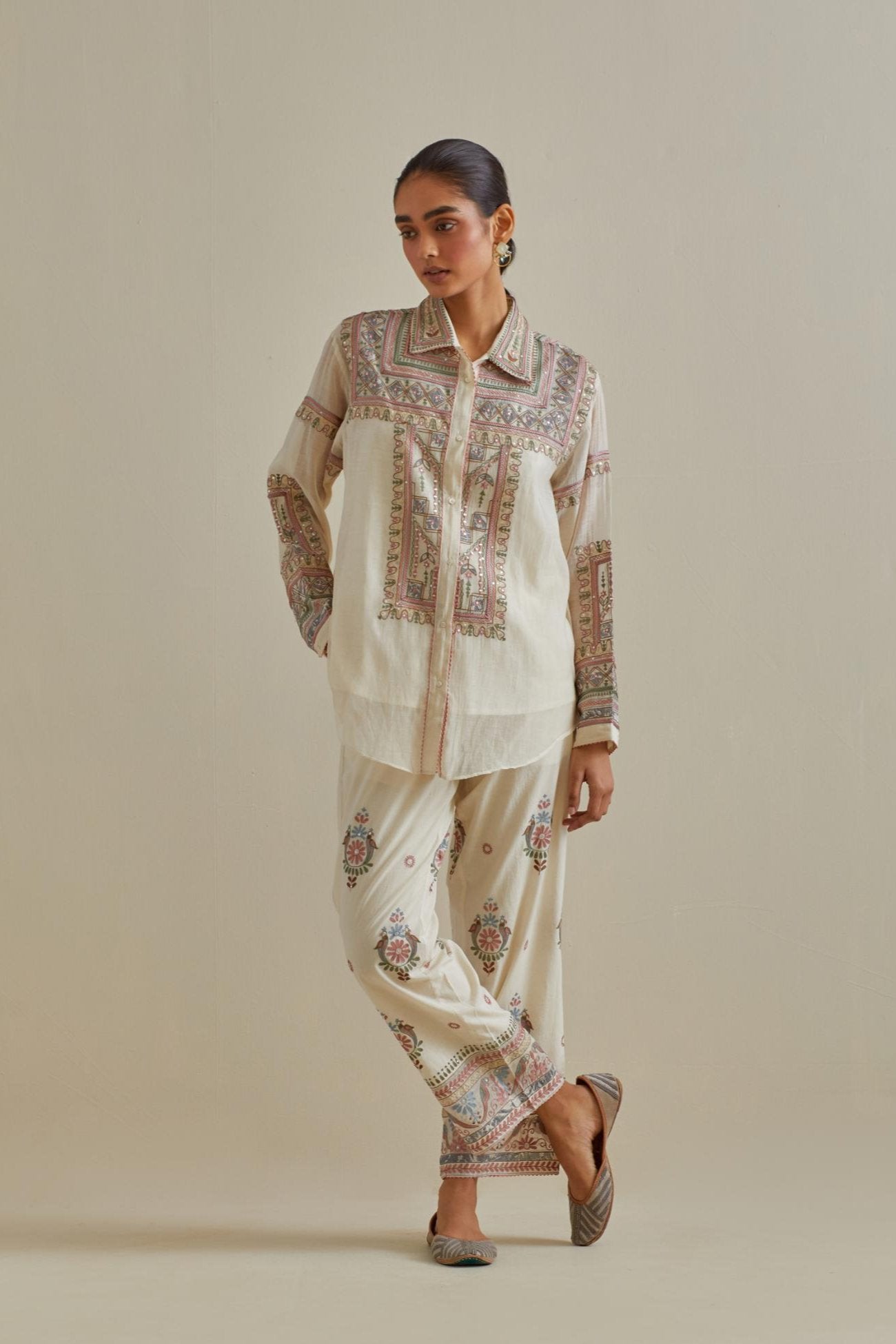 Pink and off-white cotton chanderi embroidered shirt with full sleeves, paired with off white cotton straight pants with all over multi color embroidery detailed with sequins.