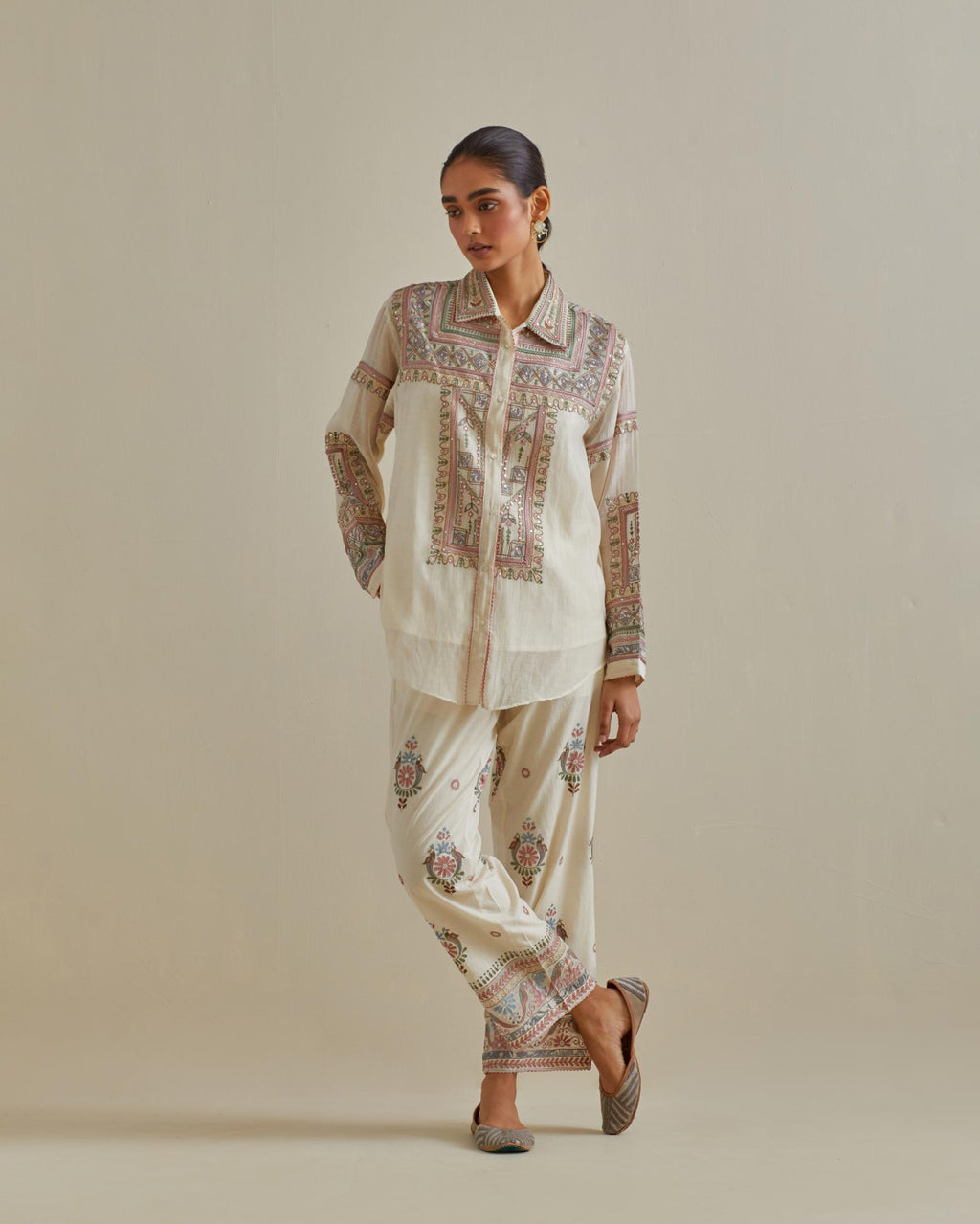 Pink and off-white cotton chanderi embroidered shirt with full sleeves, paired with off white cotton straight pants with all over multi color embroidery detailed with sequins.