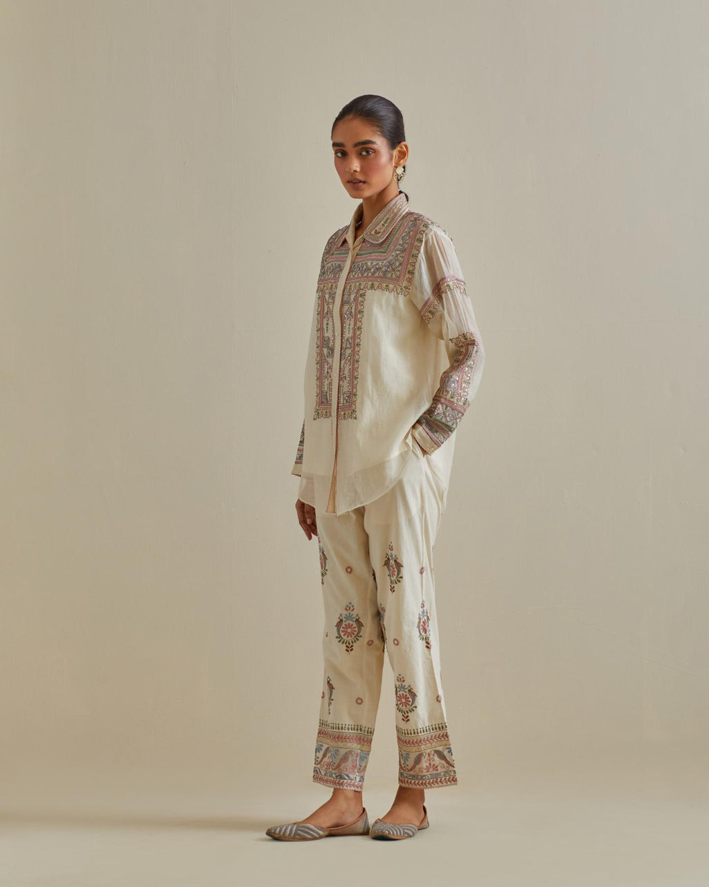 Pink and off-white cotton chanderi embroidered shirt with full sleeves, paired with off white cotton straight pants with all over multi color embroidery detailed with sequins.