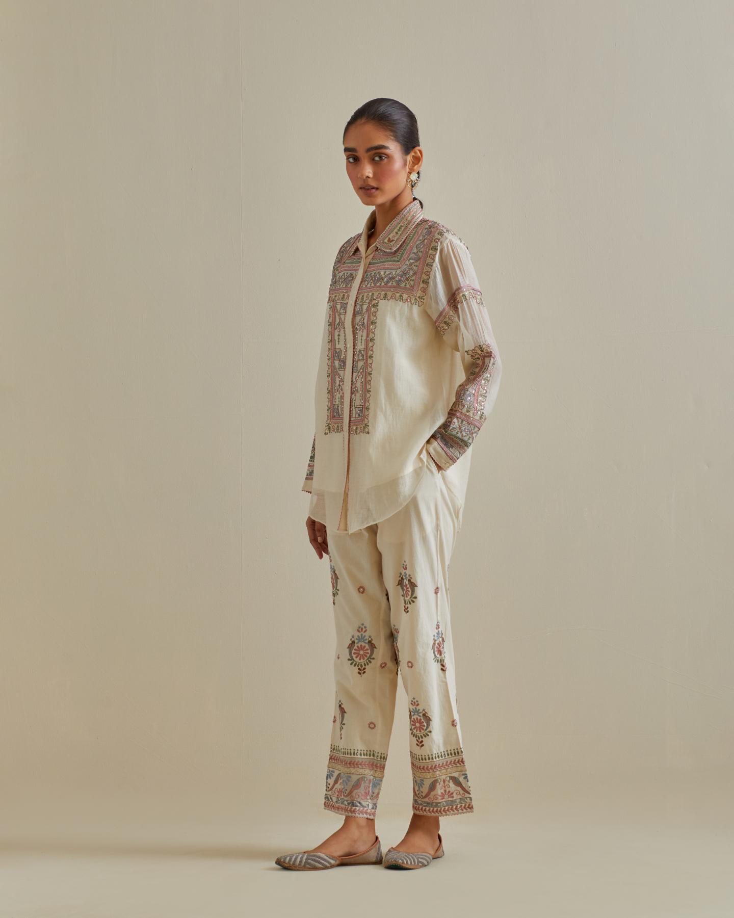 Pink and off-white cotton chanderi embroidered shirt with full sleeves, paired with off white cotton straight pants with all over multi color embroidery detailed with sequins.