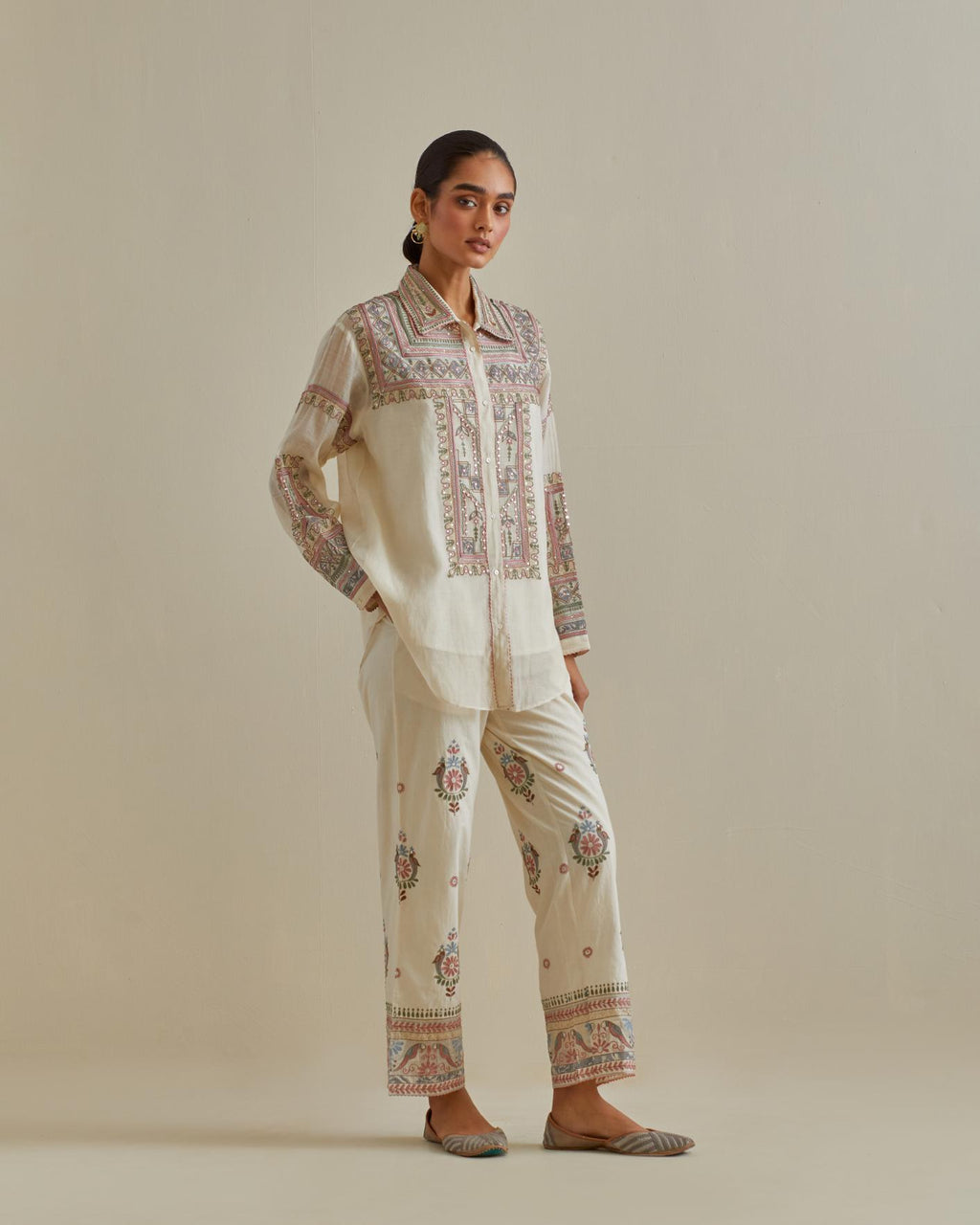 Pink and off-white cotton chanderi embroidered shirt with full sleeves, paired with off white cotton straight pants with all over multi color embroidery detailed with sequins.