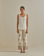 Pink and off-white cotton chanderi embroidered short top with 3/4th sleeves, paired with off white cotton straight pants with all over multi color embroidery detailed with sequins.