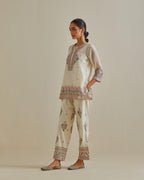 Pink and off-white cotton chanderi embroidered short top with 3/4th sleeves, paired with off white cotton straight pants with all over multi color embroidery detailed with sequins.