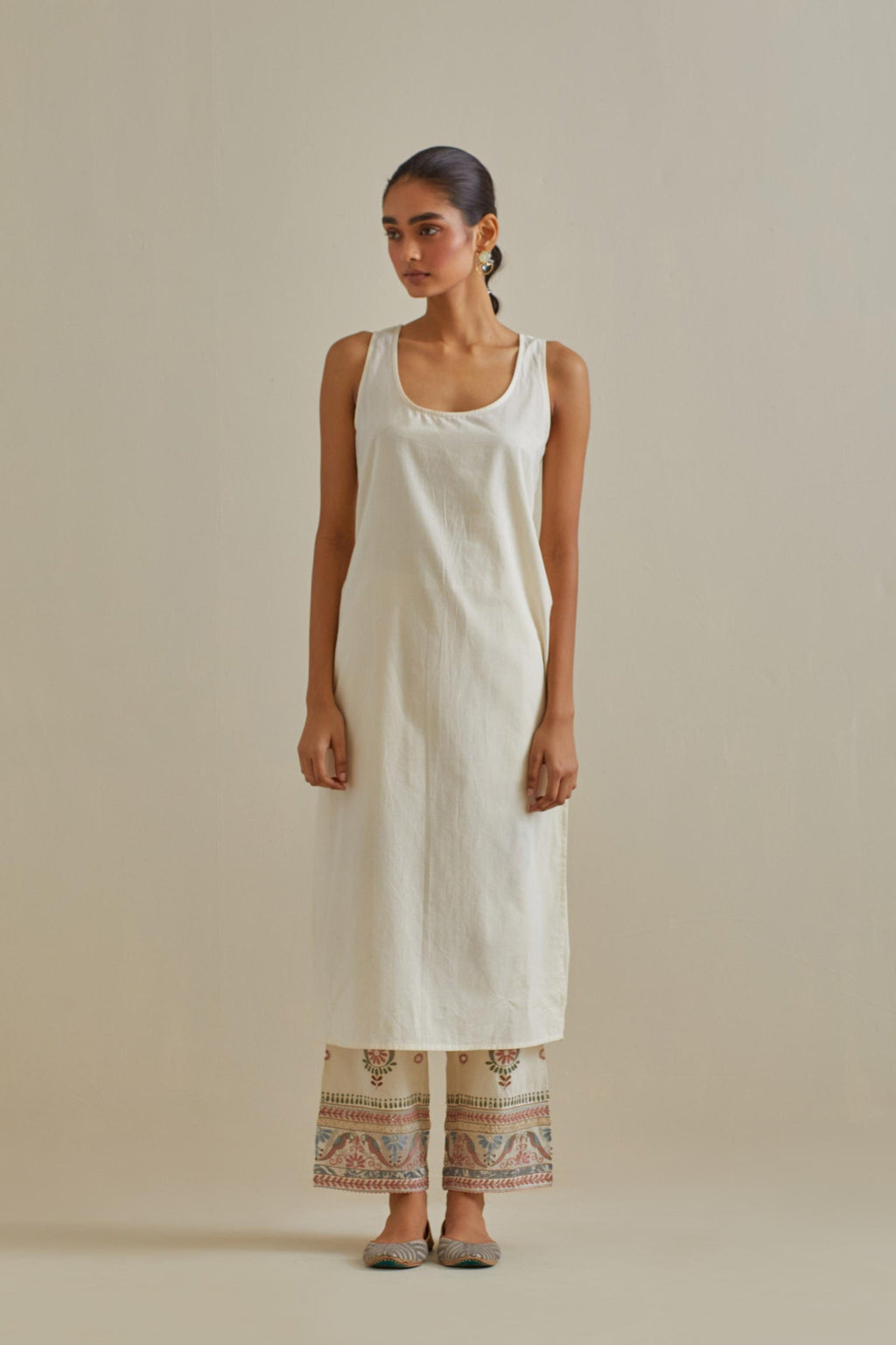 Pink and off-white cotton chanderi easy fit long kaftan detailed with patch, silk thread, mirror & sequins work, paired with off white cotton straight pants with all over multi color embroidery detailed with sequins.
