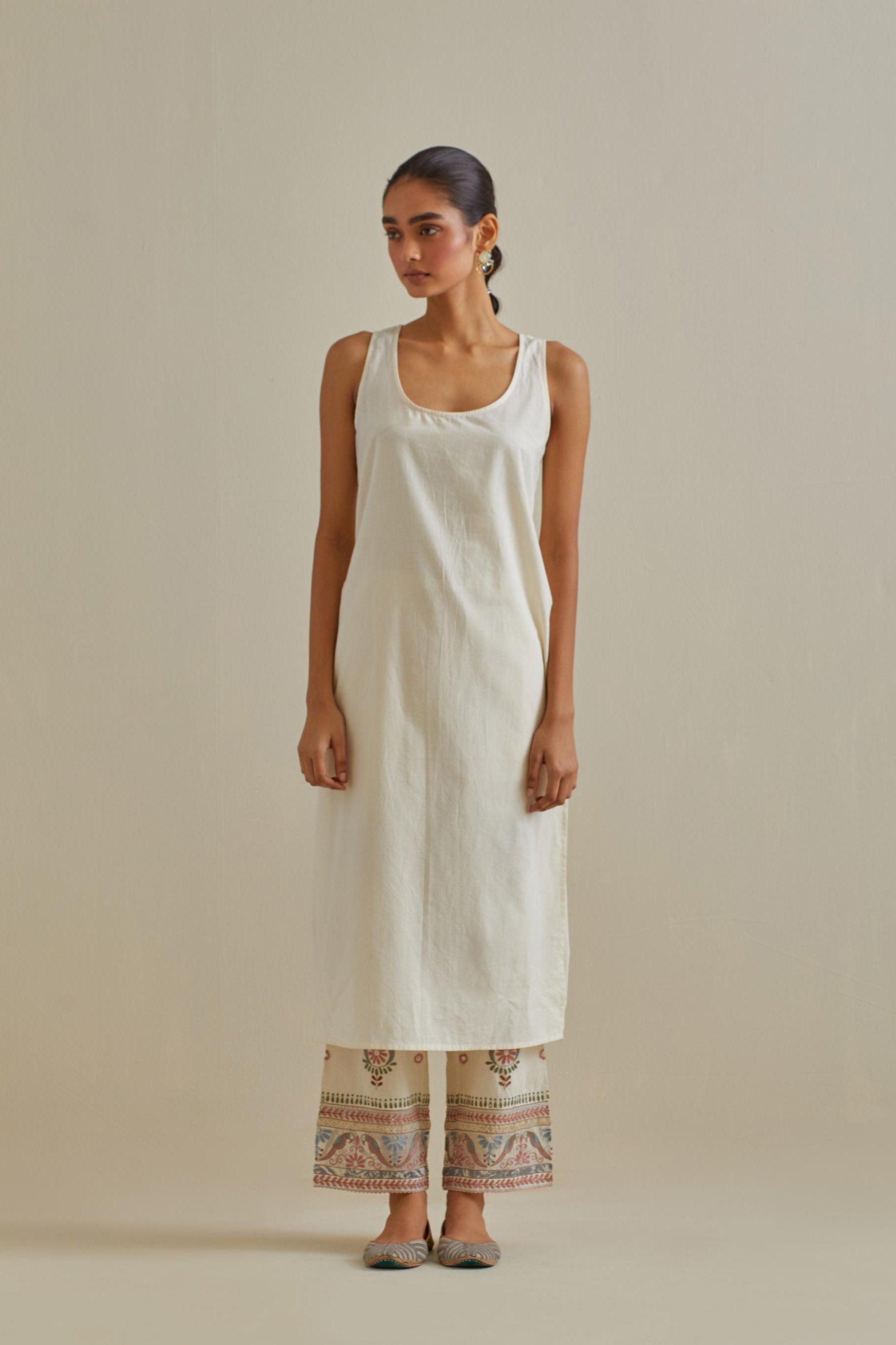 Pink and off-white cotton chanderi easy fit long kaftan detailed with patch, silk thread, mirror & sequins work, paired with off white cotton straight pants with all over multi color embroidery detailed with sequins.