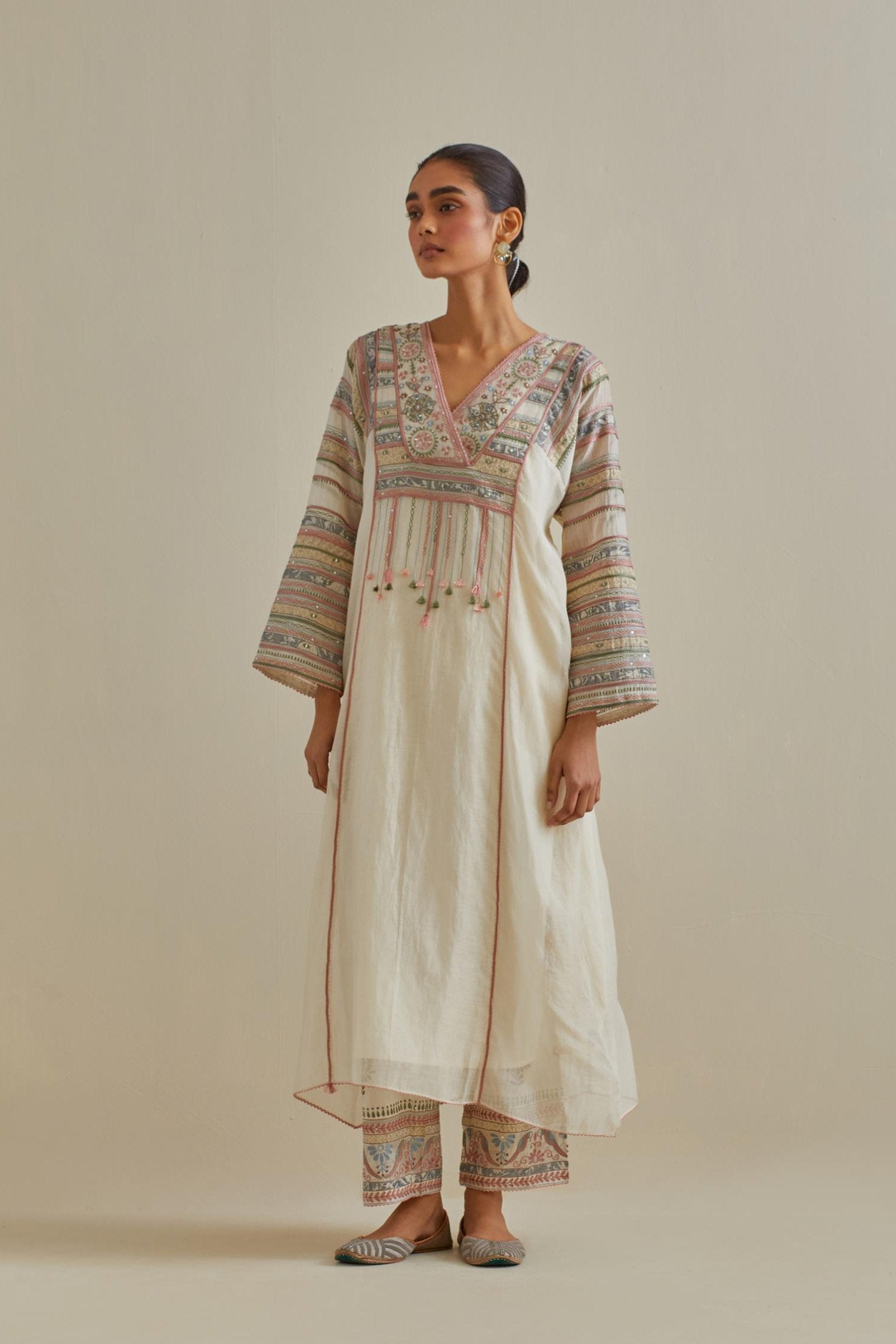 Pink and off-white cotton chanderi easy fit long kaftan detailed with patch, silk thread, mirror & sequins work, paired with off white cotton straight pants with all over multi color embroidery detailed with sequins.
