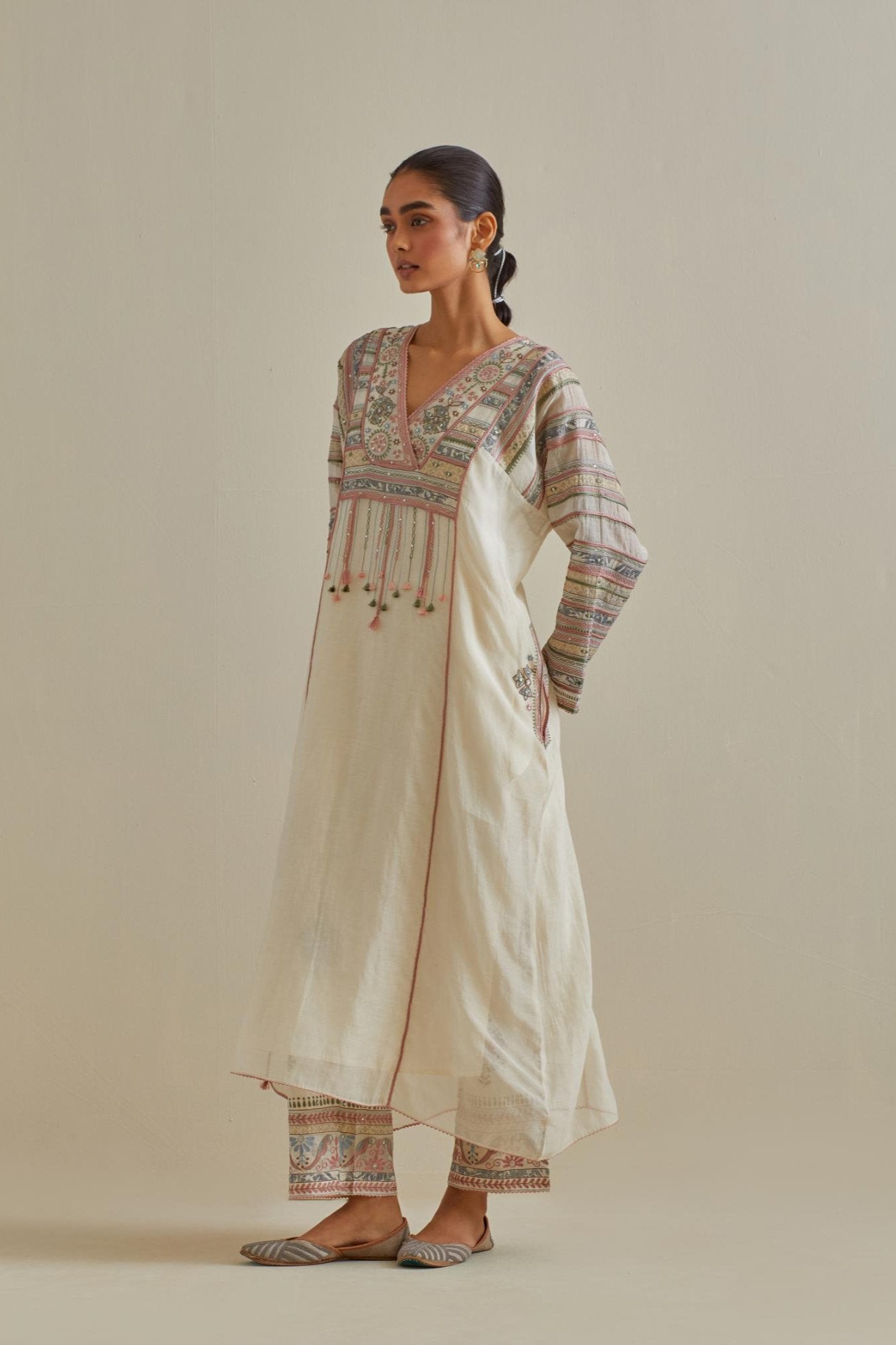 Pink and off-white cotton chanderi easy fit long kaftan detailed with patch, silk thread, mirror & sequins work, paired with off white cotton straight pants with all over multi color embroidery detailed with sequins.