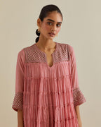 Pink cotton chanderi multi-tiered kurta dress set with 3/4 sleeves, highlighted with mirror work.