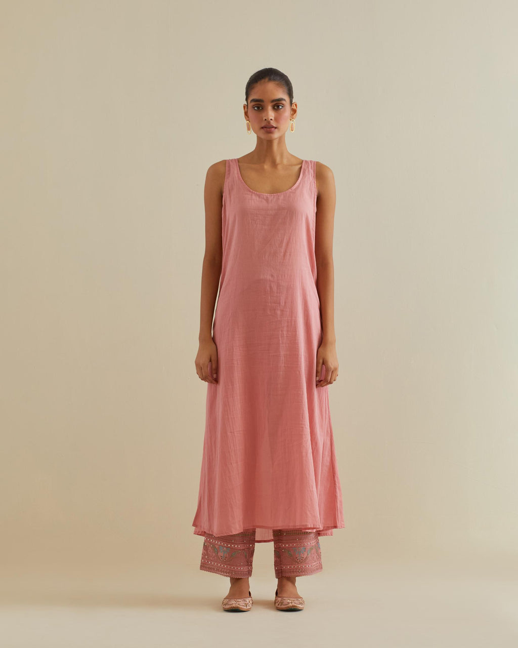 Pink cotton chanderi multi-tiered kurta dress set with 3/4 sleeves, highlighted with mirror work.