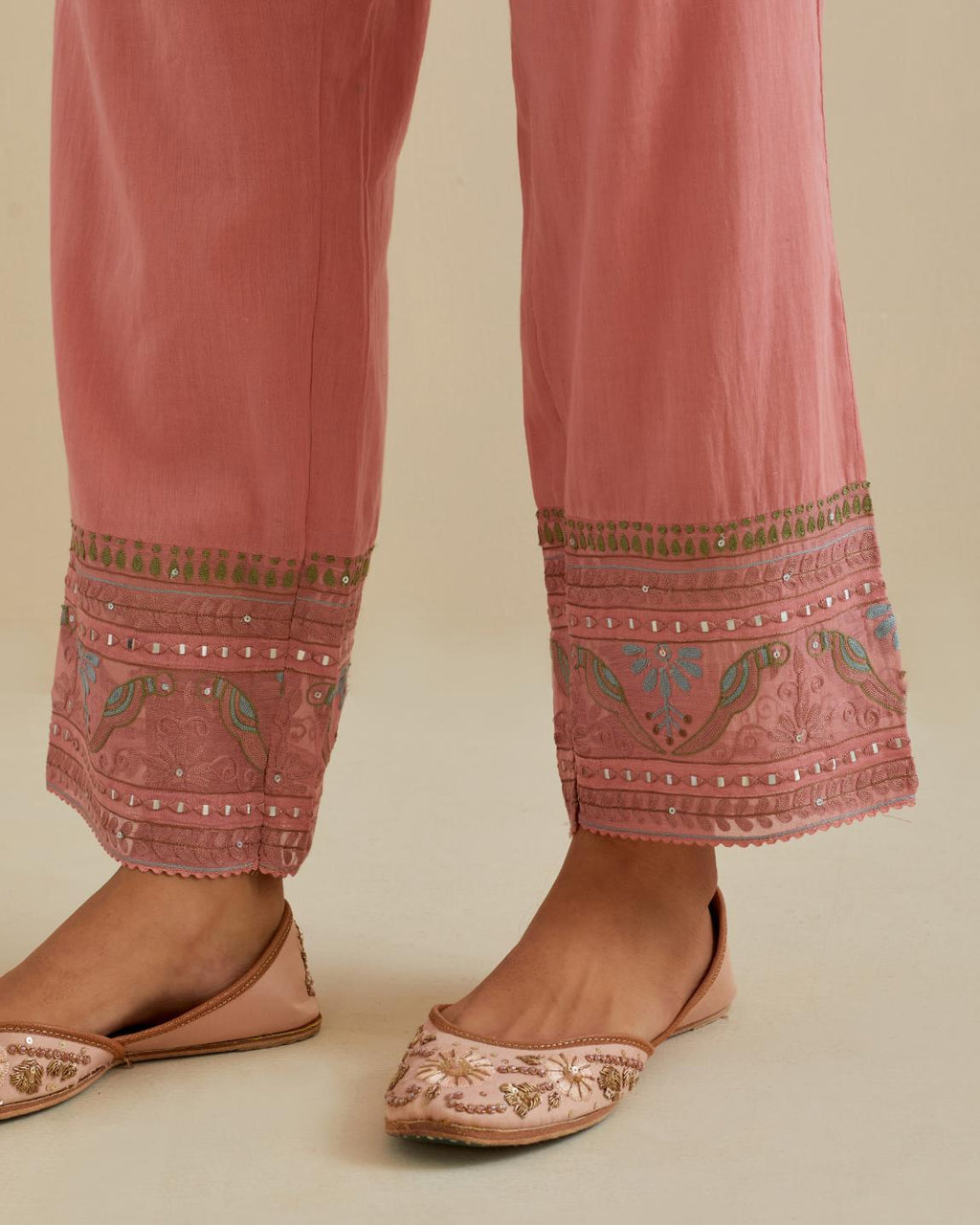 Pink straight pants with all over multi color embroidery detailed with sequins.