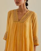 Yellow cotton chanderi kurta dress set with a V neck embroidered yoke and panels.