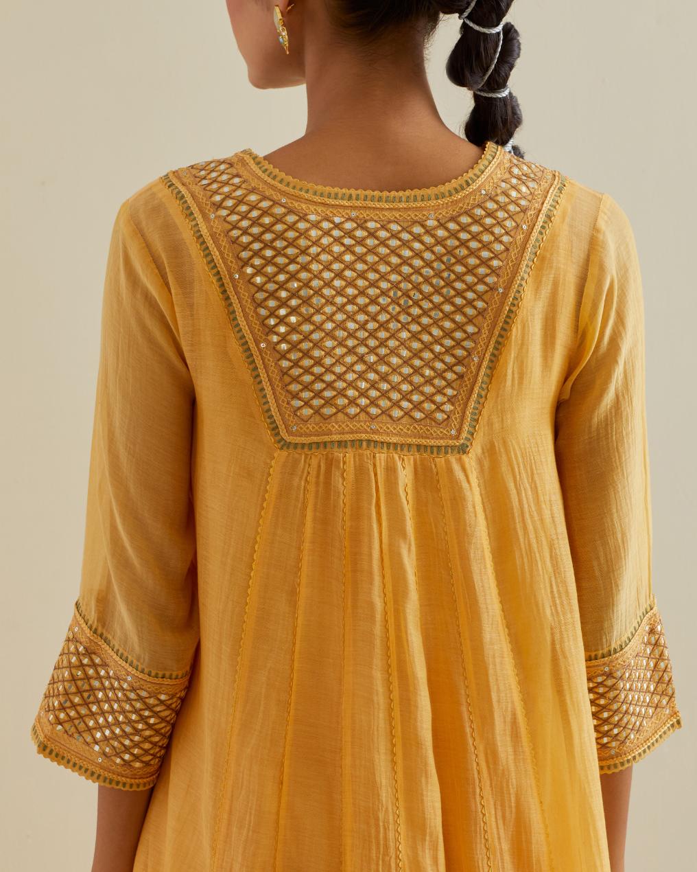 Yellow cotton chanderi kurta dress set with a V neck embroidered yoke and panels.