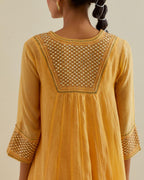 Yellow cotton chanderi kurta dress set with a V neck embroidered yoke and panels.