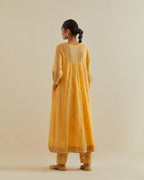 Yellow cotton chanderi kurta dress set with a V neck embroidered yoke and panels.
