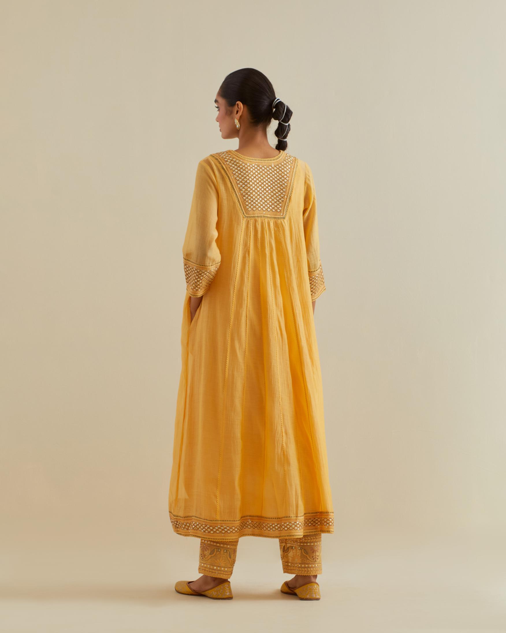 Yellow cotton chanderi kurta dress set with a V neck embroidered yoke and panels.